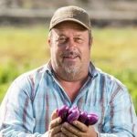 Farmer Phil Noble Holding Organic Eggplant
